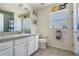 Bathroom featuring a single sink vanity, tiled floor, and whimsical decor at 14101 Vista Del Lago Blvd, Clermont, FL 34711