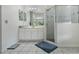 Bathroom featuring a vanity with cabinets, a mirror, and a glass shower at 14101 Vista Del Lago Blvd, Clermont, FL 34711
