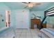 ' bedroom with fun marine-themed wall art and ceiling fan features a desk and closet at 14101 Vista Del Lago Blvd, Clermont, FL 34711