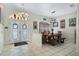 Bright dining area features tile flooring, a rustic wood table, and updated lighting fixtures at 14101 Vista Del Lago Blvd, Clermont, FL 34711