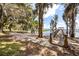 Picturesque entrance to a private dock with Spanish moss-draped trees, offering access to serene waterfront enjoyment at 14101 Vista Del Lago Blvd, Clermont, FL 34711
