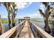 Scenic view of a wooden dock leading to a gazebo over the water, surrounded by trees draped with Spanish moss at 14101 Vista Del Lago Blvd, Clermont, FL 34711