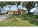 Single Gathering home featuring a well-manicured lawn, mature trees, and a two-car garage at 14101 Vista Del Lago Blvd, Clermont, FL 34711