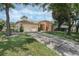Charming single-story home with a well-maintained lawn, mature trees, and an attached two-car garage at 14101 Vista Del Lago Blvd, Clermont, FL 34711