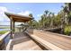 Relaxing gazebo at the end of a long wooden dock, perfect for enjoying waterfront views and peaceful moments at 14101 Vista Del Lago Blvd, Clermont, FL 34711