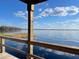Picturesque lake view from wooden dock, showcasing calm waters and a clear, blue sky with scattered clouds at 14101 Vista Del Lago Blvd, Clermont, FL 34711