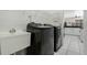 Laundry room features a utility sink, front loading washer and dryer at 14101 Vista Del Lago Blvd, Clermont, FL 34711