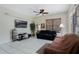 Bright living room with tile flooring, ceiling fan, and large window for lots of natural light at 14101 Vista Del Lago Blvd, Clermont, FL 34711