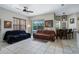 Comfortable living room with tile flooring, ceiling fan, and a sliding door to the outdoors at 14101 Vista Del Lago Blvd, Clermont, FL 34711