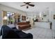 Open concept living room boasts tile floors and sliding glass doors to the outside patio at 14101 Vista Del Lago Blvd, Clermont, FL 34711