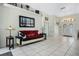 Cozy living room with neutral paint, tile floors, and plenty of natural light at 14101 Vista Del Lago Blvd, Clermont, FL 34711