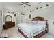Primary bedroom featuring tile flooring, a ceiling fan, and decorative shelving at 14101 Vista Del Lago Blvd, Clermont, FL 34711
