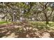 Lush, shaded park with picnic tables and a dock in the background, ideal for outdoor relaxation and waterfront access at 14101 Vista Del Lago Blvd, Clermont, FL 34711