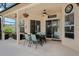Covered patio includes a dining table with outdoor seating and a ceiling fan for ultimate comfort and outdoor enjoyment at 14101 Vista Del Lago Blvd, Clermont, FL 34711