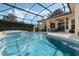 Sparkling pool featuring a spa and a screened enclosure, creating a private and serene outdoor retreat at 14101 Vista Del Lago Blvd, Clermont, FL 34711