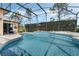 Beautiful screened-in pool area with a spa and a view of the lush backyard at 14101 Vista Del Lago Blvd, Clermont, FL 34711