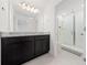 Bathroom with granite countertop, dark cabinets, and shower at 1490 Woodmont Blvd, Kissimmee, FL 34746