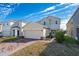 Two-story house with a two-car garage and a brick paver driveway at 1490 Woodmont Blvd, Kissimmee, FL 34746