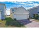 Two-story house with a two-car garage and a pond view at 1490 Woodmont Blvd, Kissimmee, FL 34746