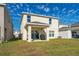 Two-story house with a backyard patio and grill at 1490 Woodmont Blvd, Kissimmee, FL 34746