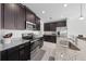 Modern kitchen with stainless steel appliances and dark brown cabinets at 1490 Woodmont Blvd, Kissimmee, FL 34746