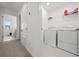 Bright laundry room with washer, dryer, and shelving at 1490 Woodmont Blvd, Kissimmee, FL 34746