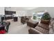 Living room with brown leather furniture and sliding glass doors at 1490 Woodmont Blvd, Kissimmee, FL 34746