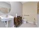 Clean bathroom featuring a pedestal sink and grab bar at 1542 Wax Myrtle Way, Haines City, FL 33844