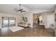 Living area with hardwood floors, view into kitchen and access to patio at 1571 Cheri Ct, Kissimmee, FL 34744