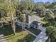 Aerial view of a lovely two-story home with blue shutters, a spacious lawn, and mature trees in a quiet neighborhood at 1595 Stone Trl, Deltona, FL 32725
