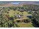 Aerial view of sprawling acreage with manicured lawns, barn, and other outdoor amenities at 1595 Stone Trl, Deltona, FL 32725