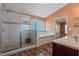 Bathroom with a large shower and a soaking tub beside a glass block window at 1595 Stone Trl, Deltona, FL 32725