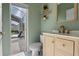 Stylish bathroom featuring a wooden vanity, modern faucet, and a view of a screened-in patio at 1595 Stone Trl, Deltona, FL 32725