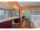 Bathroom with double sinks, large mirrors, walk-in shower, soaking tub and wood flooring at 1595 Stone Trl, Deltona, FL 32725