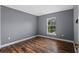 This bedroom has hard surface floors, modern paint and a window overlooking the backyard at 1595 Stone Trl, Deltona, FL 32725