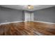 Bedroom features wood floors, ceiling fan, and closet space, with ample natural light at 1595 Stone Trl, Deltona, FL 32725