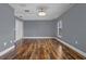 Bedroom features wood-look floors, a ceiling fan and a window with outside views at 1595 Stone Trl, Deltona, FL 32725