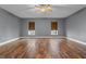 Bedroom with wood floors, ceiling fan, and windows providing ample natural light at 1595 Stone Trl, Deltona, FL 32725