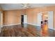 Spacious bedroom with ceiling fan featuring hardwood floors and ample natural light from open doorway at 1595 Stone Trl, Deltona, FL 32725
