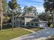 Stunning two-story home featuring lush landscaping, beautiful stucco, and a spacious three-car garage at 1595 Stone Trl, Deltona, FL 32725