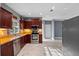 Well-lit kitchen features stainless steel appliances, marble floors and granite counters at 1595 Stone Trl, Deltona, FL 32725