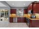 Charming kitchen with stainless steel appliances, granite counters, and cherry wood cabinetry at 1595 Stone Trl, Deltona, FL 32725