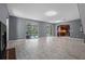 Open floor plan showcasing the seamless transition from the living room to the kitchen and outdoor pool area at 1595 Stone Trl, Deltona, FL 32725