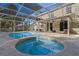 Gorgeous screened-in pool and spa area with an attached covered lanai for outdoor relaxation and entertainment at 1595 Stone Trl, Deltona, FL 32725