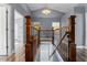 Staircase with wood banister and wrought iron spindles, offering a classic and elegant design at 1595 Stone Trl, Deltona, FL 32725