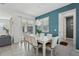 Dining area with white table and chairs, and teal accent wall at 2052 Fleming Mist Pl, Kissimmee, FL 34747