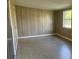 Bedroom with wood paneling and tile flooring at 2381 Fairgren Ave, Deltona, FL 32738