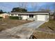 Ranch style home with attached garage and driveway at 2381 Fairgren Ave, Deltona, FL 32738