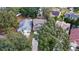 Aerial view of two houses with driveways, surrounded by lush green trees at 2705 Grantham Ct, Orlando, FL 32835