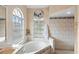 Relaxing bathroom with a garden tub, large window, and tile shower at 2705 Grantham Ct, Orlando, FL 32835